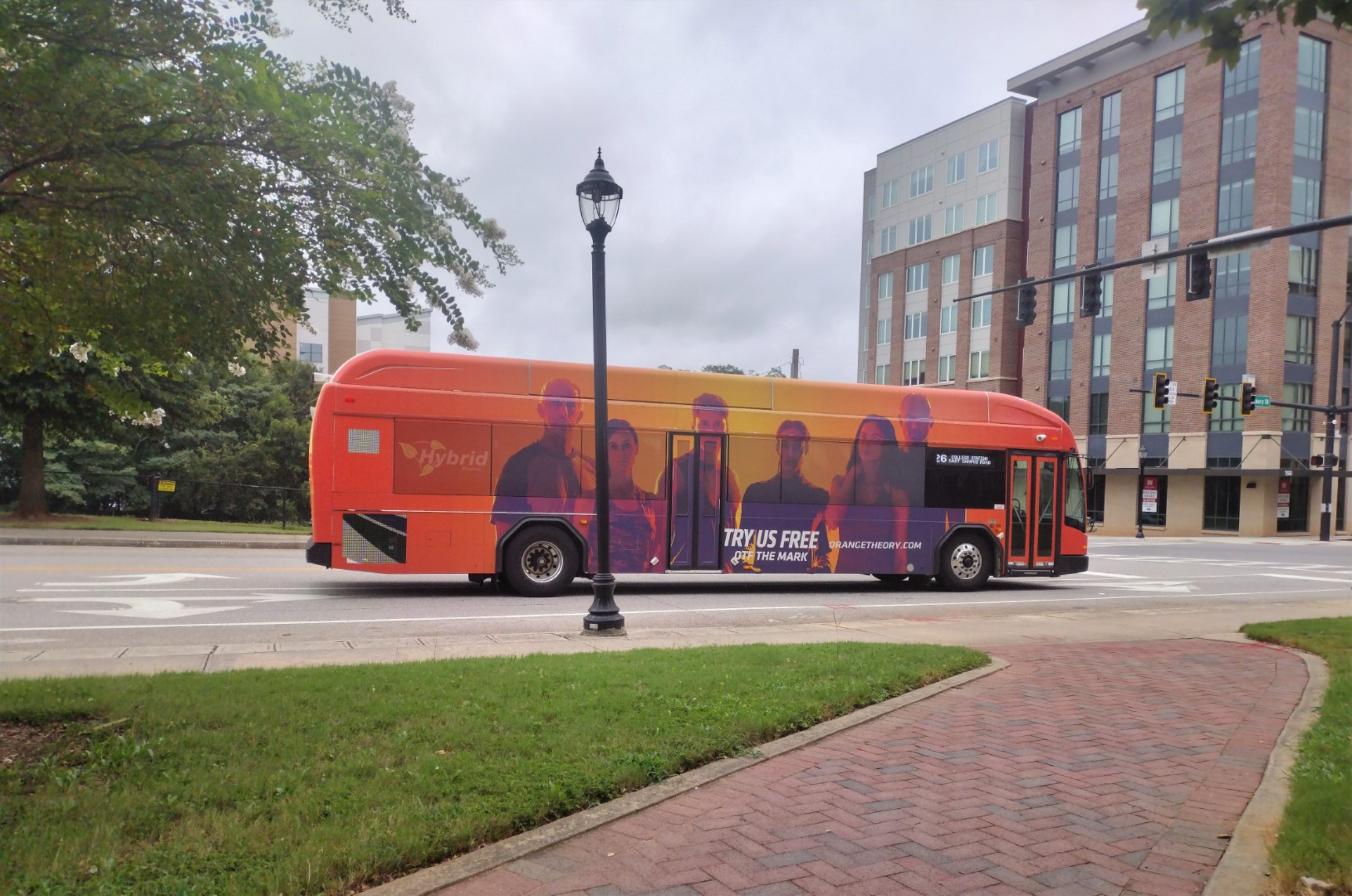 Orange Theory Fitness ad wrap on a bus in Athens