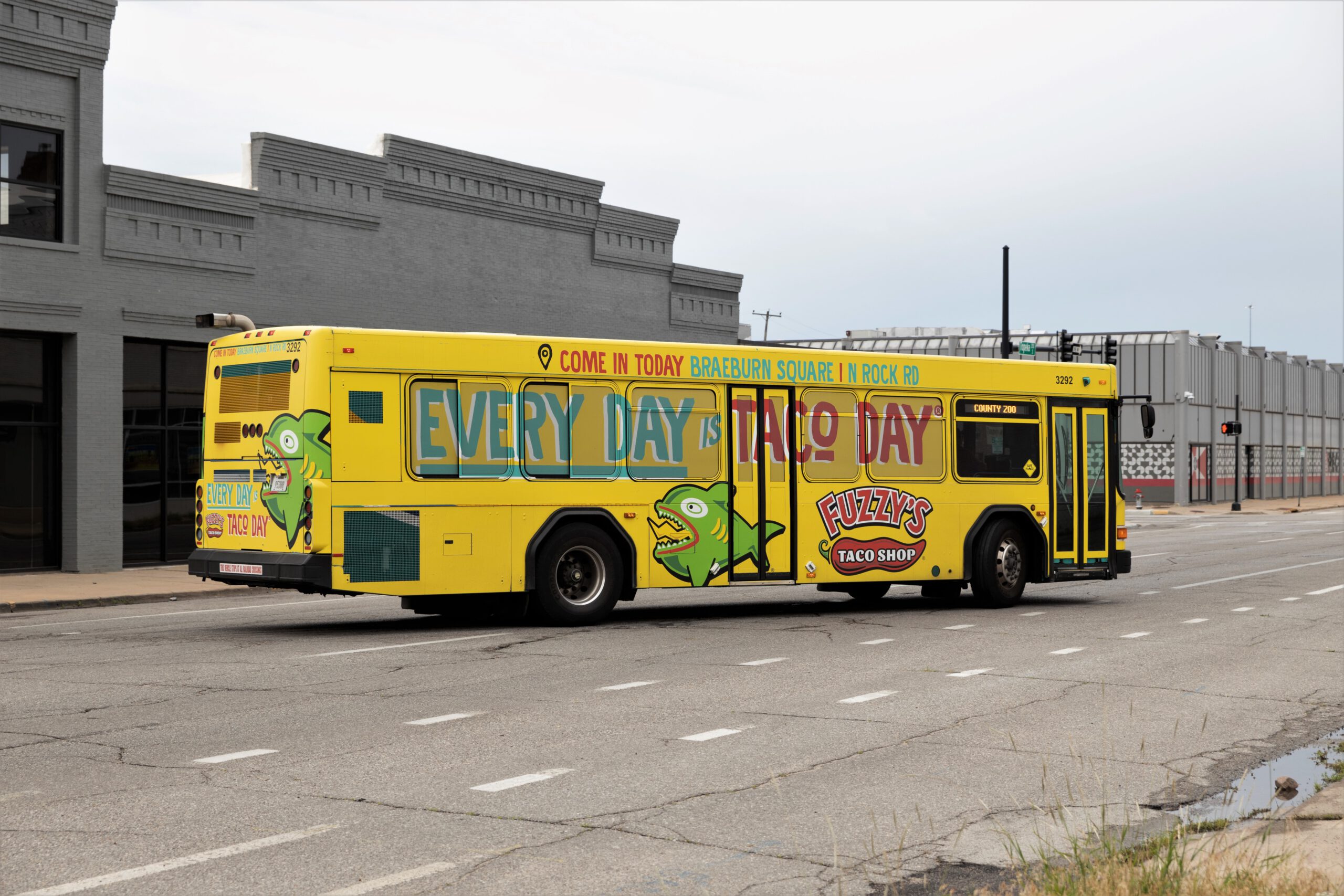 Advertisement wrap on a bus for Fuzzy's Taco Shop