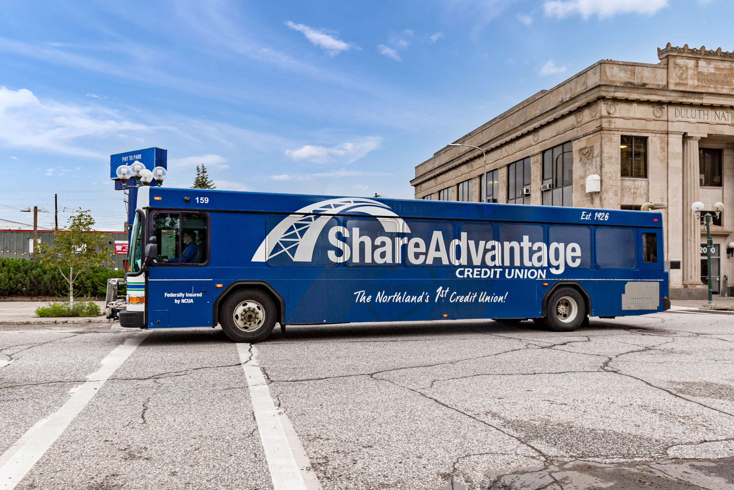 Blue advertisement wrap on a bus for Share Advantage